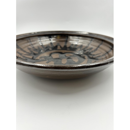 345 - A mid 20th century drip glazed studio pottery circular bowl - approx. 34cm diameter