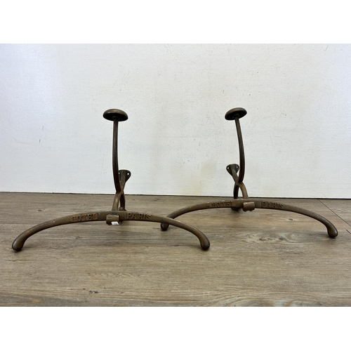 407 - A pair of Hotel Paris cast metal wall hanging tailor's jacket coat hooks