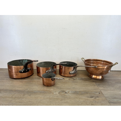 418 - Five pieces of late 19th/early 20th century copper kitchenware, one colander and four graduating sau... 