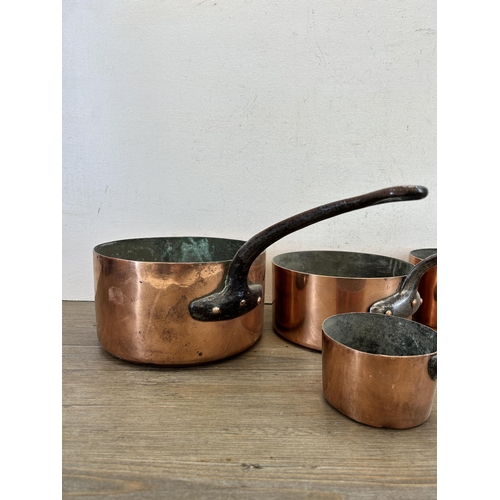 418 - Five pieces of late 19th/early 20th century copper kitchenware, one colander and four graduating sau... 