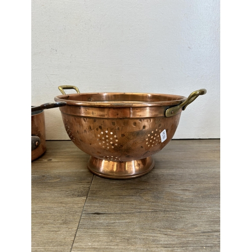 418 - Five pieces of late 19th/early 20th century copper kitchenware, one colander and four graduating sau... 