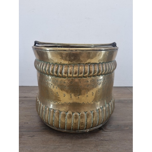 426 - A late 19th/early 20th century Middle Eastern engraved brass coal scuttle - approx. 30cm high x 33cm... 