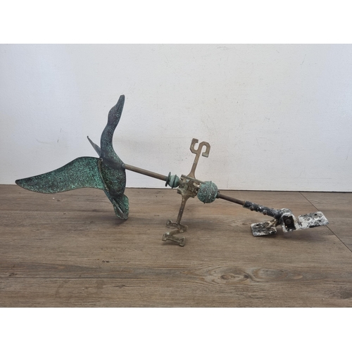 428 - A cast metal and copper weathervane in the form of a bird in flight - approx. 70cm high