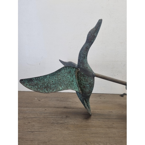 428 - A cast metal and copper weathervane in the form of a bird in flight - approx. 70cm high