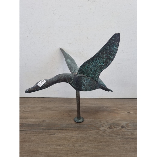 428 - A cast metal and copper weathervane in the form of a bird in flight - approx. 70cm high