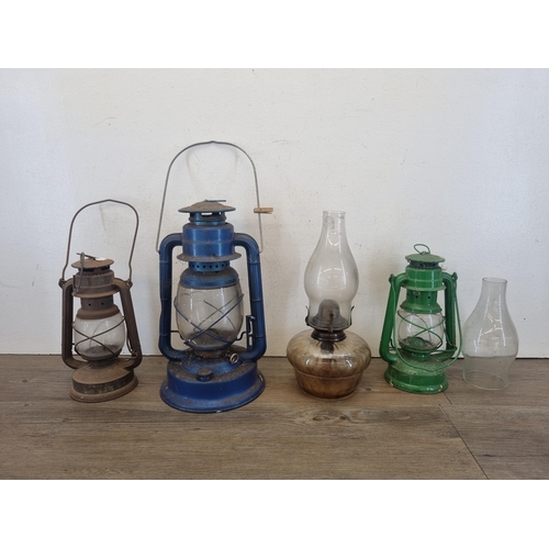 432 - Four paraffin lamps and lanterns to include Dietz No.90, Feuer Hand No. 1275 etc.