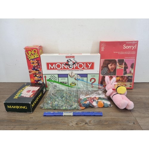 447 - A collection of toys and games to include Monopoly, Mah-jong, Duracell soft toy, marbles, VTech game... 