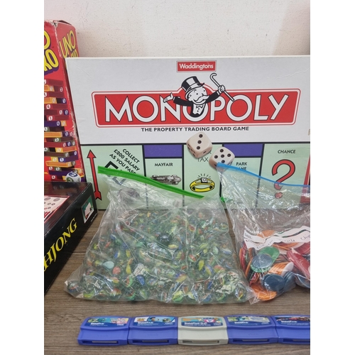 447 - A collection of toys and games to include Monopoly, Mah-jong, Duracell soft toy, marbles, VTech game... 