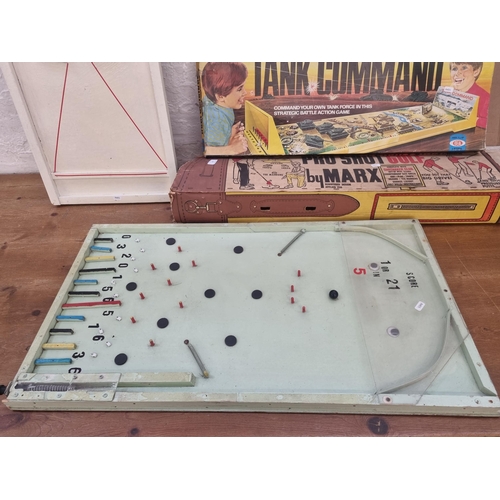 453 - A collection of vintage games to include boxed Marx Pro Shot Golf putting set, boxed Ideal Tank Comm... 