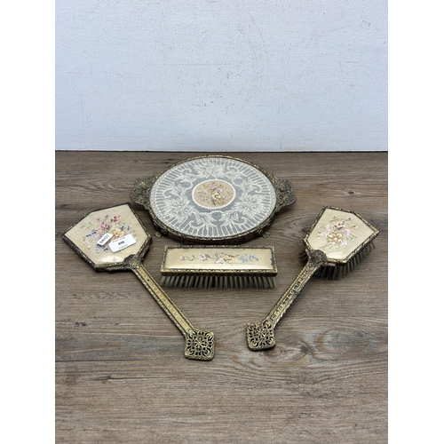 498 - Four Petit Point gilt metal and embroidered dressing table accessories