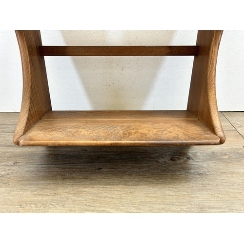 512 - A mid 20th century Ercol elm wall mountable two tier waterfall bookshelf - approx. 52cm high x 43cm ... 