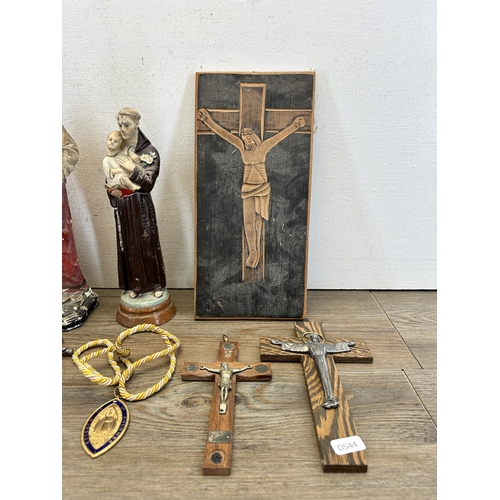 527 - A collection of religious artifacts to include chalkware Jesus figurine, carved oak panel of crucifi... 