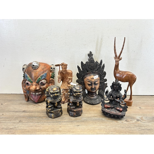 528 - A collection of tourist items to include heavily carved hand painted tribal wall mask, treenware ani... 