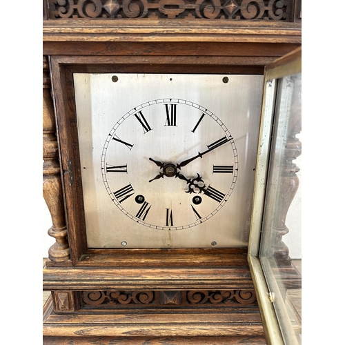 553 - An early 20th century W & H In Sch heavily carved oak cased chiming mantel clock with key and pendul... 