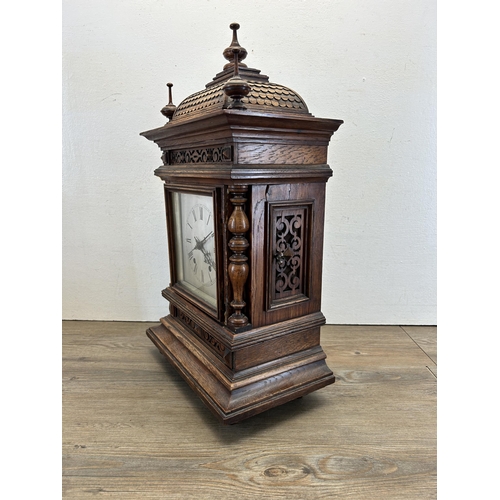 553 - An early 20th century W & H In Sch heavily carved oak cased chiming mantel clock with key and pendul... 