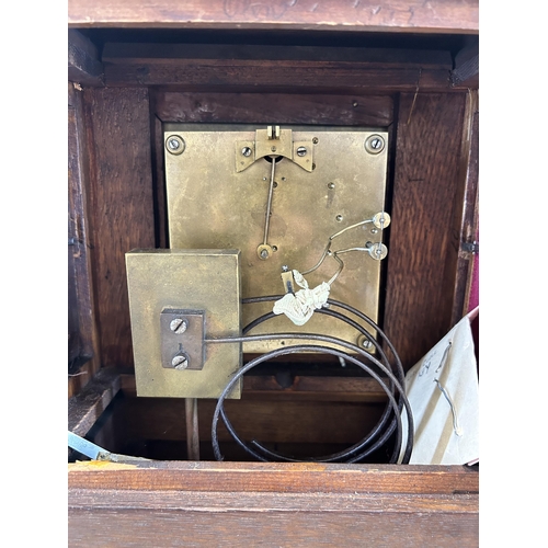 553 - An early 20th century W & H In Sch heavily carved oak cased chiming mantel clock with key and pendul... 