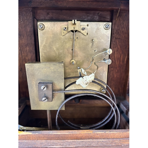 553 - An early 20th century W & H In Sch heavily carved oak cased chiming mantel clock with key and pendul... 