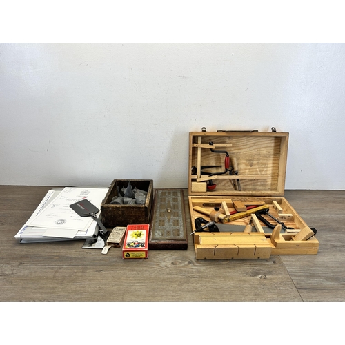 558 - A collection of items to include lead sea fishing weights, early 20th century oak and engraved brass... 