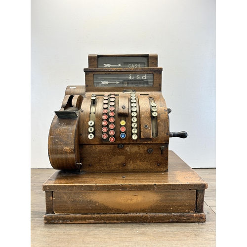 560 - An early 20th century National oak cash register - ref no. DN956177 822-X-SH - approx. 57cm high x 5... 