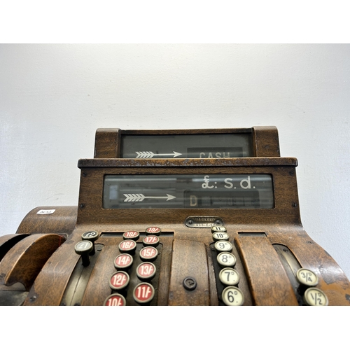 560 - An early 20th century National oak cash register - ref no. DN956177 822-X-SH - approx. 57cm high x 5... 