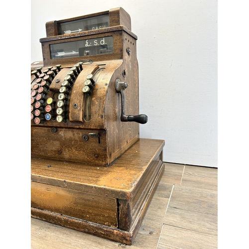 560 - An early 20th century National oak cash register - ref no. DN956177 822-X-SH - approx. 57cm high x 5... 