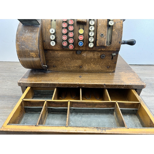 560 - An early 20th century National oak cash register - ref no. DN956177 822-X-SH - approx. 57cm high x 5... 