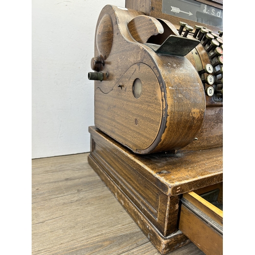 560 - An early 20th century National oak cash register - ref no. DN956177 822-X-SH - approx. 57cm high x 5... 