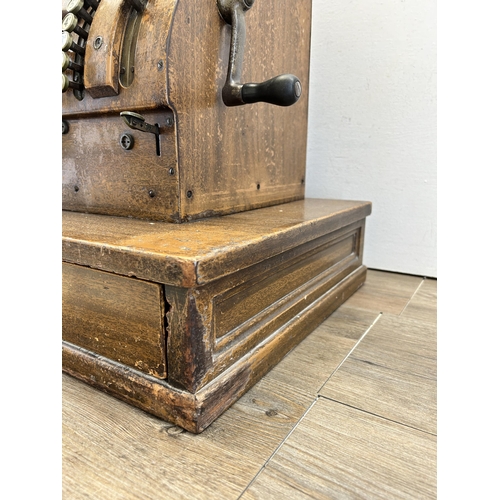 560 - An early 20th century National oak cash register - ref no. DN956177 822-X-SH - approx. 57cm high x 5... 