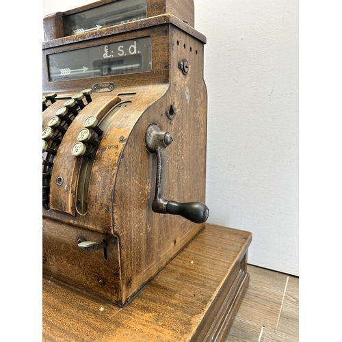 560 - An early 20th century National oak cash register - ref no. DN956177 822-X-SH - approx. 57cm high x 5... 