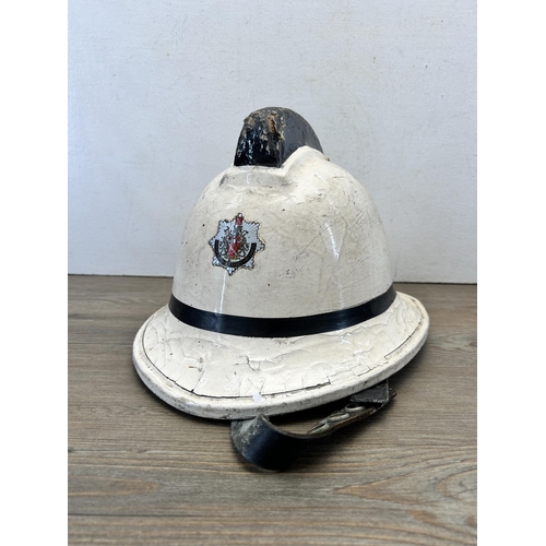 565 - A 1980s Greater Manchester County Fire Service safety helmet - approx. 23cm high x 36cm long x 27cm ... 