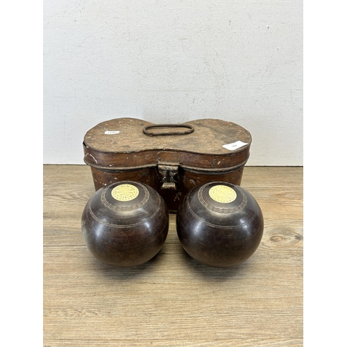 577 - A cased pair of late 19th century Thomas Taylor No. 3 Bias lignum vitae and bone crown green bowls