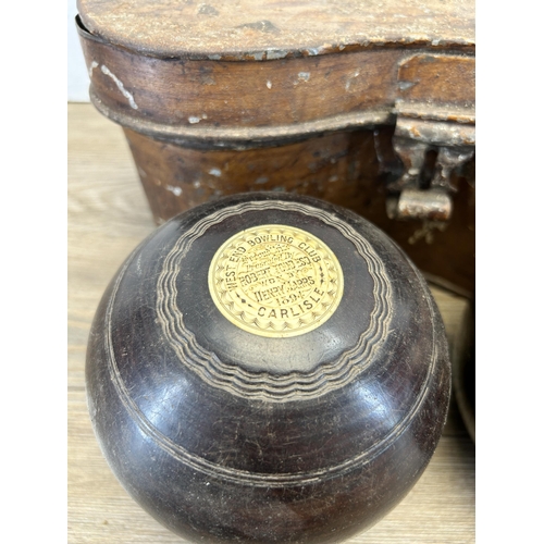 577 - A cased pair of late 19th century Thomas Taylor No. 3 Bias lignum vitae and bone crown green bowls