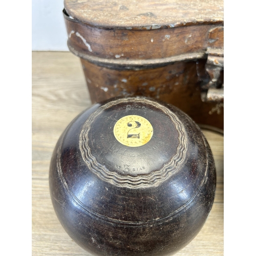 577 - A cased pair of late 19th century Thomas Taylor No. 3 Bias lignum vitae and bone crown green bowls