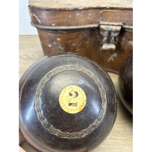 577 - A cased pair of late 19th century Thomas Taylor No. 3 Bias lignum vitae and bone crown green bowls