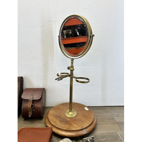 580 - A collection of early/mid 20th century vanity items to include brass shaving mirror on wooden circul... 