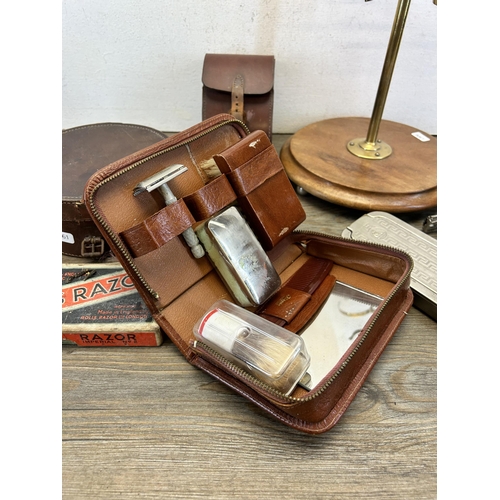 580 - A collection of early/mid 20th century vanity items to include brass shaving mirror on wooden circul... 