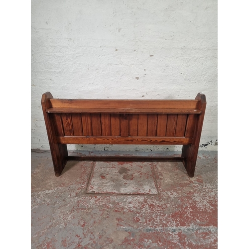 101 - A late 19th century pitch pine church pew - approx. 93cm high x 153cm wide x 41cm deep