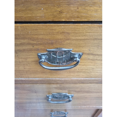 69 - An Edwardian oak chest of three drawers