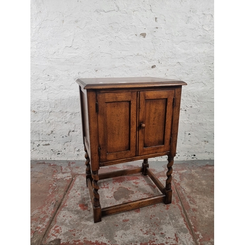 72 - A mid 20th century oak credence cupboard on barley twist supports - approx. 73cm high x 49cm wide x ... 