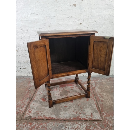 72 - A mid 20th century oak credence cupboard on barley twist supports - approx. 73cm high x 49cm wide x ... 