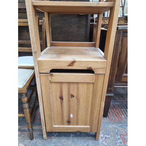 74 - A pine three tier shelving unit with lower cupboard door