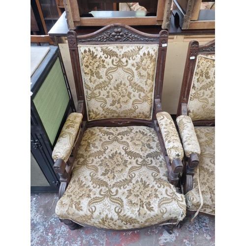 78 - A pair of Victorian carved mahogany and floral upholstered his and hers armchairs