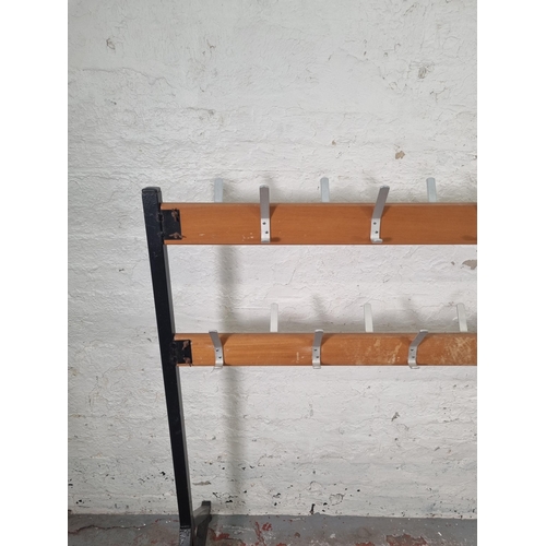 83 - A mid 20th century beech and black metal free standing school coat rack - approx. 125cm high x 154cm... 