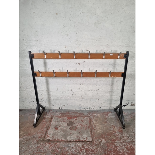 84 - A mid 20th century beech and black metal free standing school coat rack - approx. 125cm high x 154cm... 