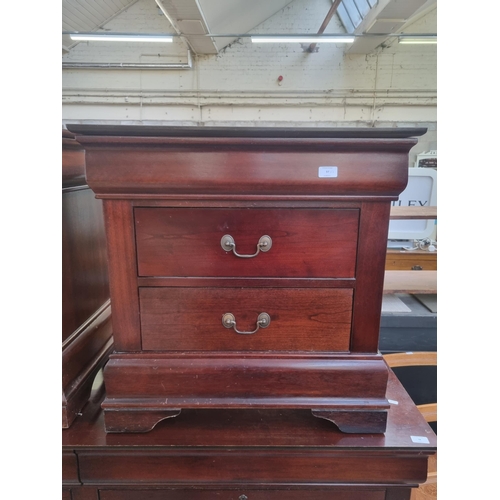 97 - A pair of Georgian style mahogany bedside chests of two drawers