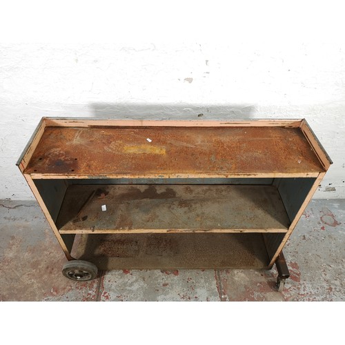 779 - An industrial grey metal three tier shelving unit on castors - approx. 95cm high x 124cm wide x 32cm... 