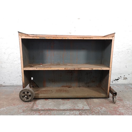 779 - An industrial grey metal three tier shelving unit on castors - approx. 95cm high x 124cm wide x 32cm... 