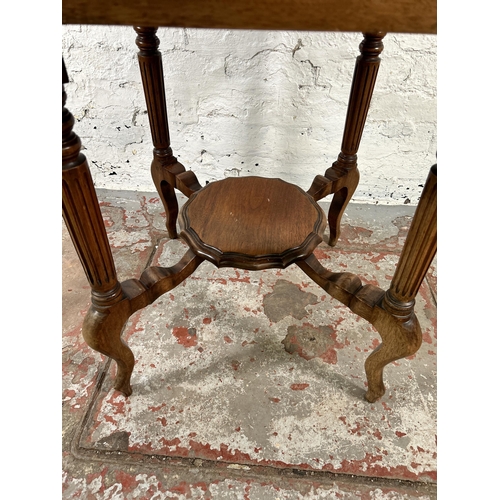 31 - A late 19th/early 20th century walnut serpentine two tier occasional table