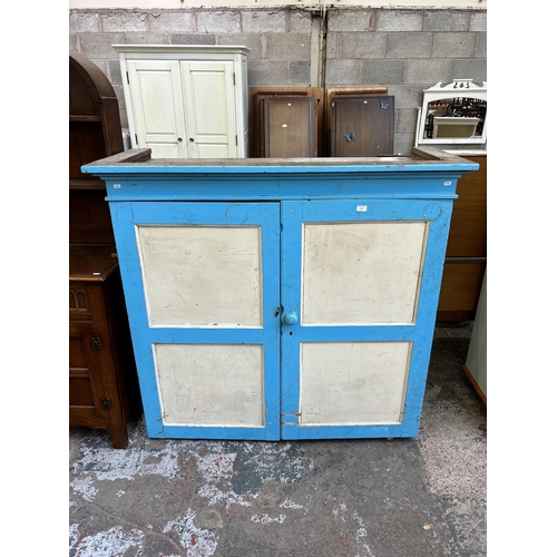 34 - A Victorian painted pine two door housekeeper's cupboard - approx. 133cm high x 140cm wide x 53cm de... 