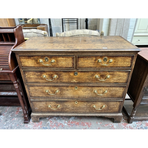 41 - A George III oak and mahogany crossbanded chest of two short over three long drawers with bracket su... 